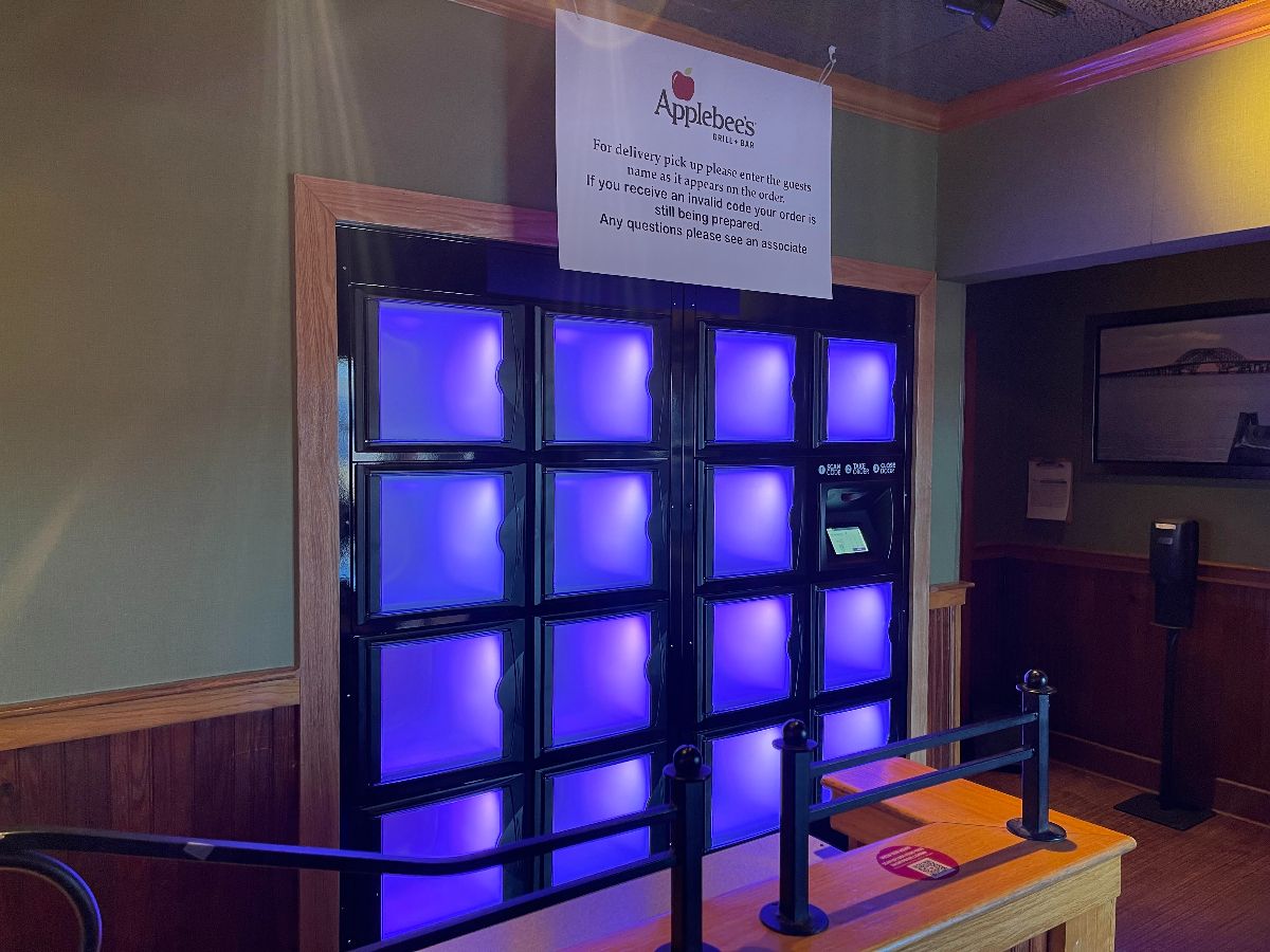 Image of a glowing blue bay of lockers inside an Applebee's